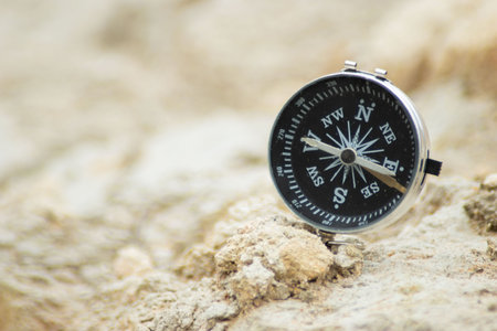 Compass on the sand. Selective focus and shallow depth of field.の写真素材