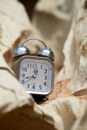 Retro alarm clock on a natural background. Shallow depth of field.の写真素材