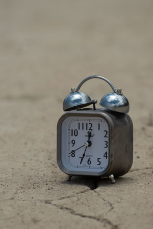 Alarm clock on the ground. Time concept. Selective focus.