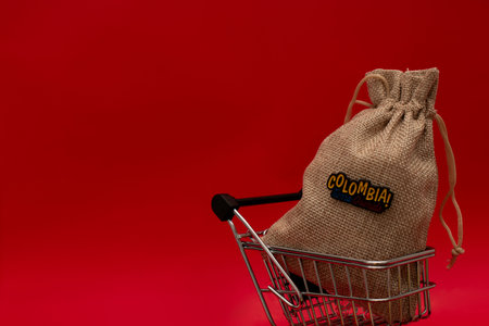 Shopping cart with a bag of coffee on a red background.の写真素材