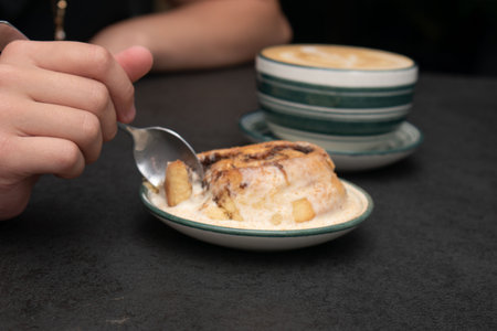 Coffee with cinnamon buns on black stone background.の写真素材