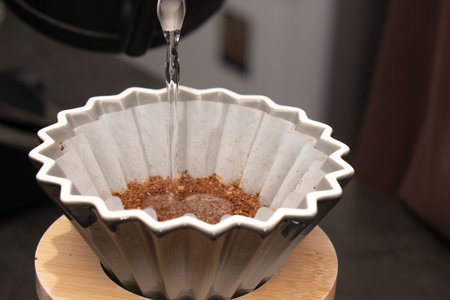 Coffee machine pouring coffee into paper cup, close-upの写真素材