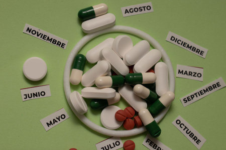 Pills and tablets in the form of a circle on a green backgroundの写真素材