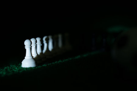 Chess game. Close up of white chess pieces on green backgroundの写真素材