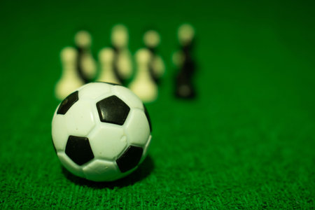 soccer ball and pawns on a green background, close-upの写真素材