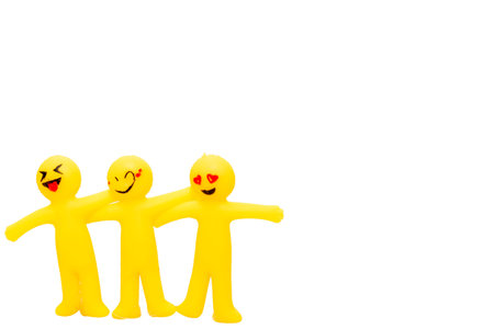 Happy family of yellow plasticine figures isolated on a white background.