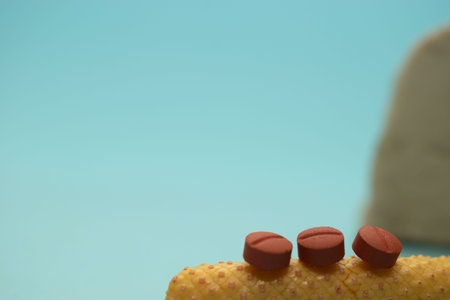 Tablets on a yellow object on a blue background with copy space