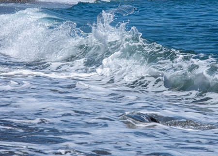 Sea foam and blue water in the shore