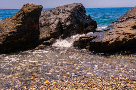 Tropical coast with stones and sandの写真素材