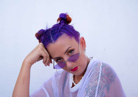 Colorful artist young woman with purple hair and sunglassesの写真素材