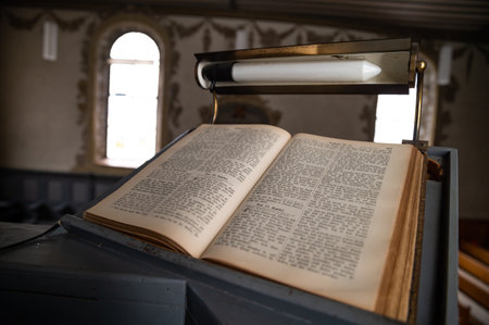 Old Vintage German Bible on Pulpit in European Medieval Church Close up Blurred Background and Copy Spaceの写真素材