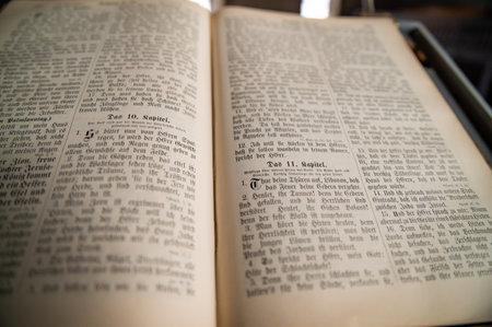 Old Vintage German Bible on Pulpit in European Medieval Church Close up Blurred Background and Copy...