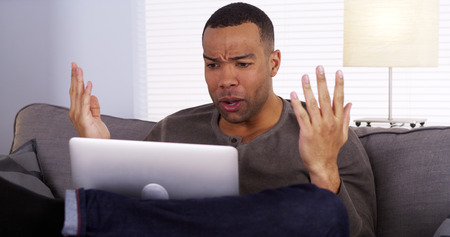 Black guy streaming the game on his laptop