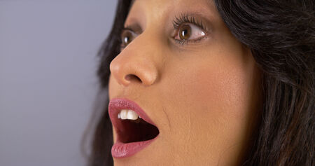 Closeup of Hispanic woman looking surprised