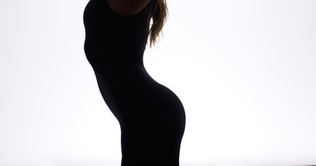 Silhouette of pretty woman dancingの写真素材