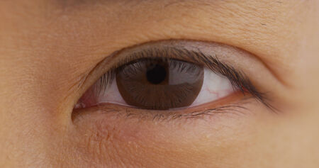 Closeup of single Japanese woman's eyeの写真素材