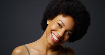 Slow pan up casual black woman laughing and smilingの写真素材