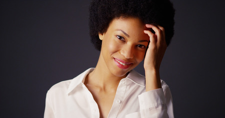 Attractive young black woman with afro looking at cameraの写真素材