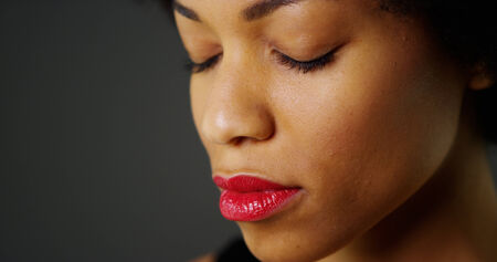 Close up slow pan up of African woman with eyes closedの写真素材