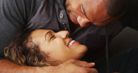 Closeup of African boyfriend kissing his girlfriendの写真素材