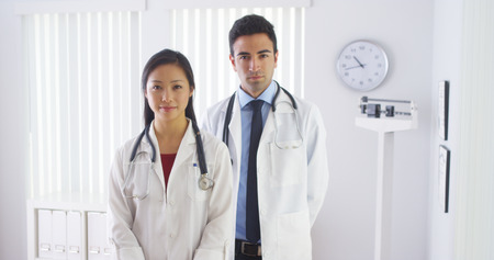 Happy doctors standing in officeの写真素材