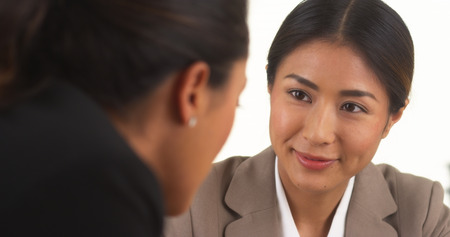 Japanese businesswoman talking with Mexican colleagueの写真素材