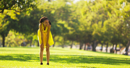 African woman leaning on kneesの写真素材
