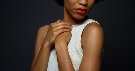 Sexy black woman standing in a white gownの写真素材