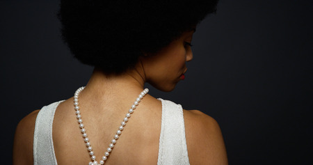 Black woman wearing elegant pearl necklaceの写真素材
