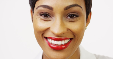 Close up front view of pretty black woman with red lipstick smiling