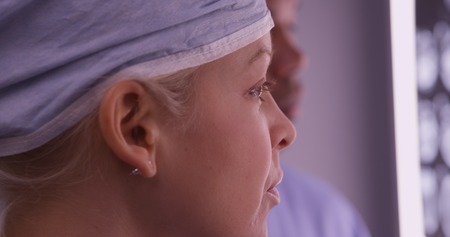 Closeup of woman surgeon looking at xrays