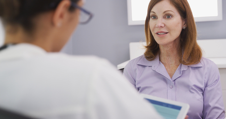 Close up of lovely senior patient talking with young female medical doctor