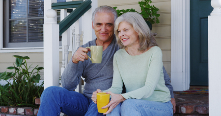 Mature couple sitting on porch talking