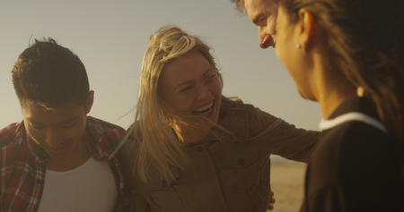 Friends laughing and having fun at the beachの写真素材