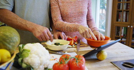 Senior couple cooking together in the kitchenの写真素材