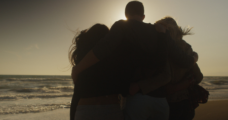 Beautiful group of friends watching the sunset togetherの写真素材