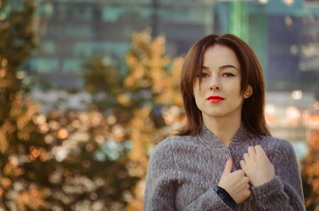 portrait of a beautiful woman in the autumn city park