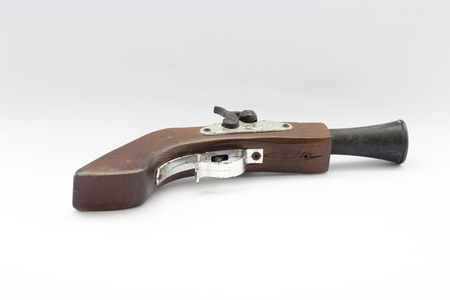 A relate ancient wood gun white isolated