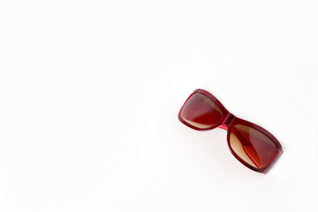 red plastic sun glasses with brown lens isolatedの写真素材