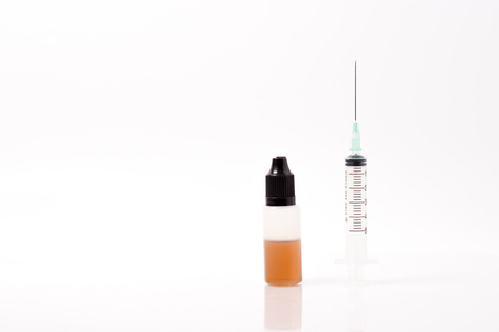 Syringe and liquid drug on white background isolatedの写真素材