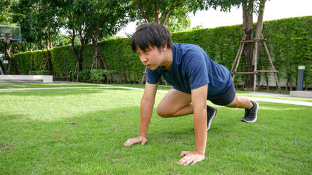 Young asian guy exersising at parkの写真素材