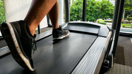 Close-up leg running on treadmill at fitness clubの写真素材