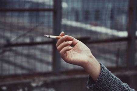 smoker's hand holding a cigaretteのeditorial素材