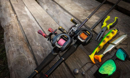 Fishing rods and fishing tackle on a wooden pier. Close-up.の写真素材