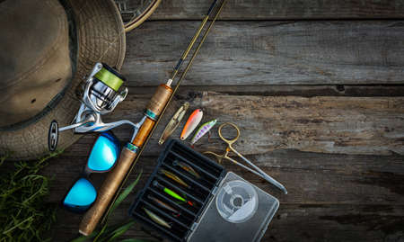 Fishing tackle on a wooden background. Top view with copy space.の写真素材
