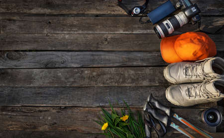 Flat lay composition with hiking equipment on wooden background. Space for textの写真素材