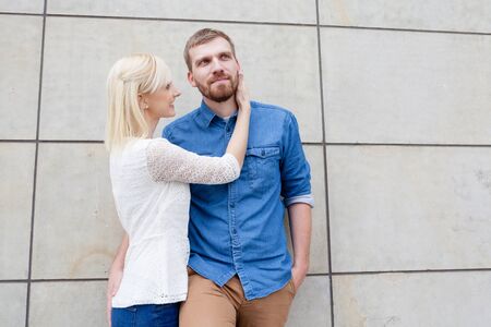 couple posing in front of wallの写真素材