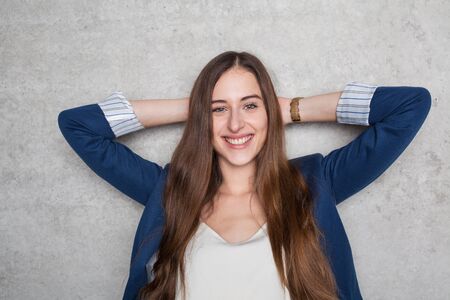 happy business woman relaxing at wallの写真素材
