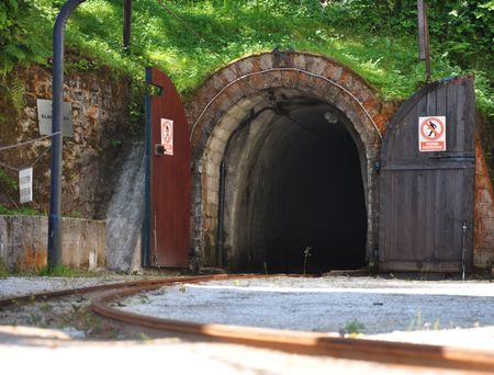 Mine entrance with tracks and open wooden doorsの写真素材