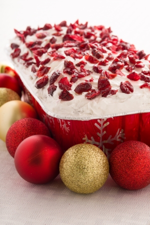 Frosted Cake with White Icing and Holiday Decorationsの写真素材
